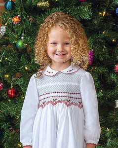 Girls Long Sleeved Traditional Hand Smocked Dress, Embroidered Applique Detail to Bodice, Hemline and Sleeves. Peter Pan Collar