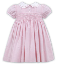 Hand Smocked Short Sleeved Dress in Candy Stripe Fabric. Contrasting Detailed Peter Pan Collar, Button and Pleated Detail.