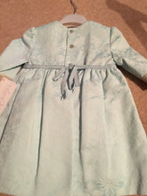 Girls Long Sleeved Dress in a Damask Fabric with Embriodered Cotton Trim and Velvet Bow Detail on Front and Sleeves