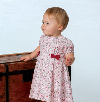 Girls Short Sleeved Floral Dress with Pleat and Velvet Bow Detail to Bodice.