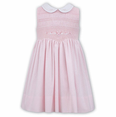 Beautiful Hand Smocking to Waist with Delicate Embroidered Detail to Bodice and Contrasting Peter Pan. Sleeveless Dress Finished in a Delicate Spot Print Fabric