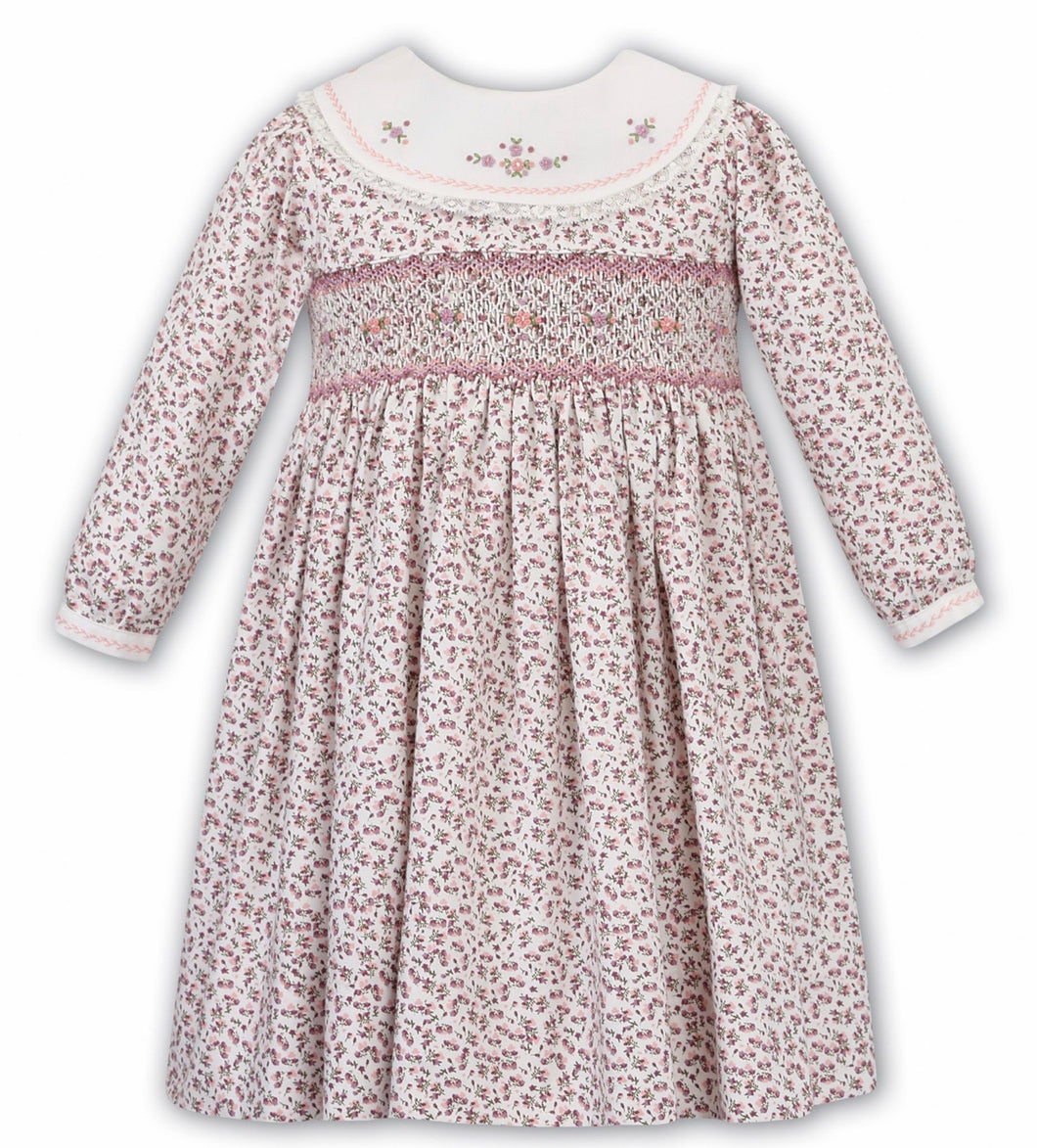 Girls Floral Long Sleeved Dress Traditional Hand Smocking and Embroidery. Contrasting Trim to Sleeves and Yoke Style Neckline