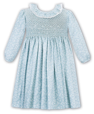 Girls Traditional Hand Smocked Long Sleeved Dress in Pretty Floral Print. Embroidered Detail with Lace Trim Frilled Collar